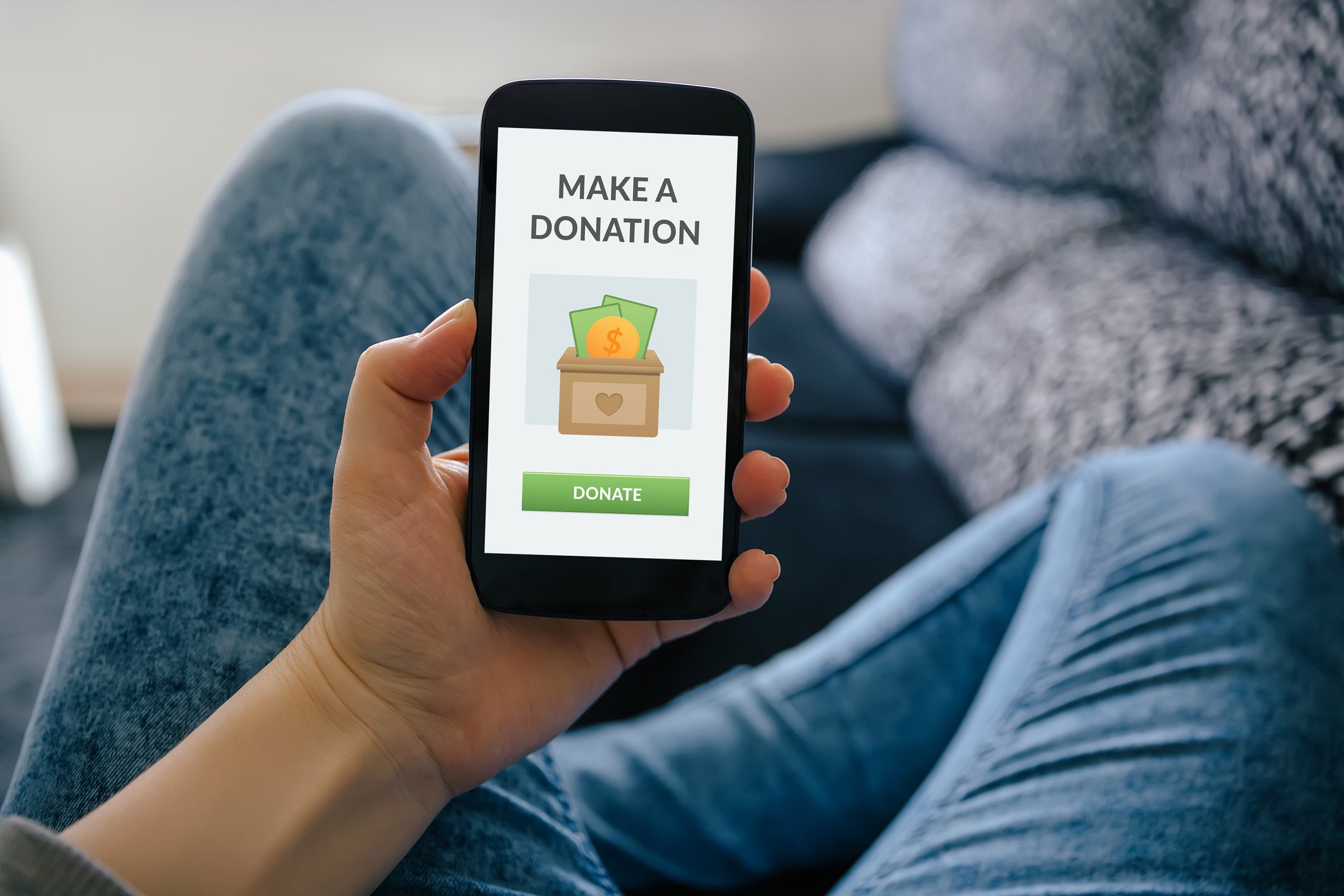 A person makes a donation on their phone