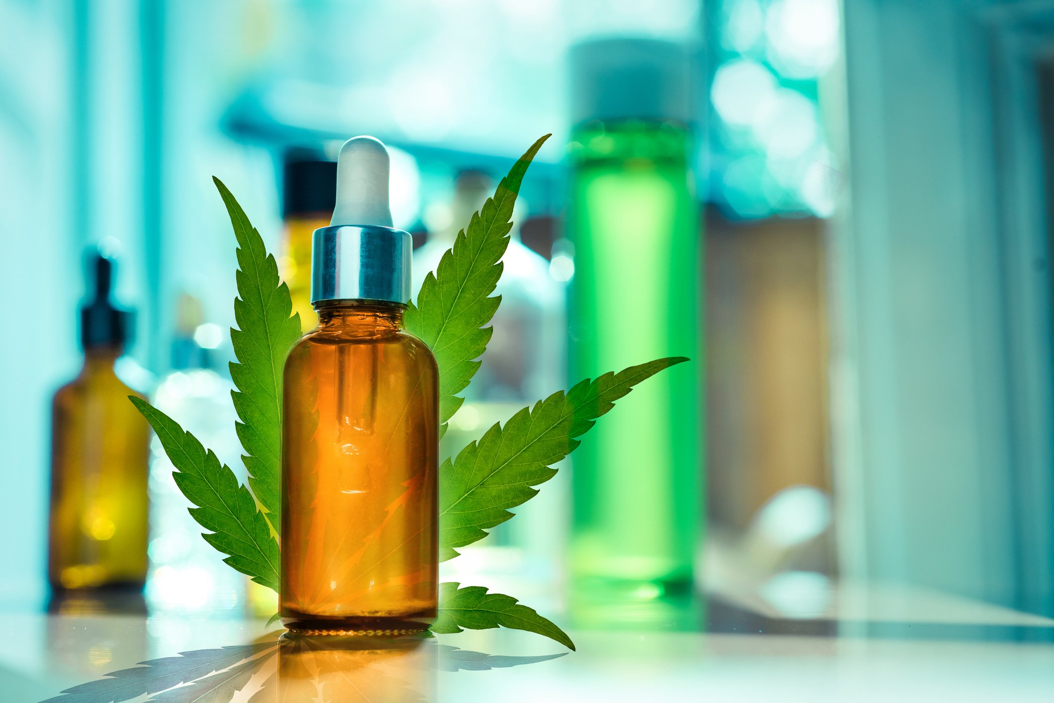 CBD oil, tincture and cannabis leaf in a medical laboratory