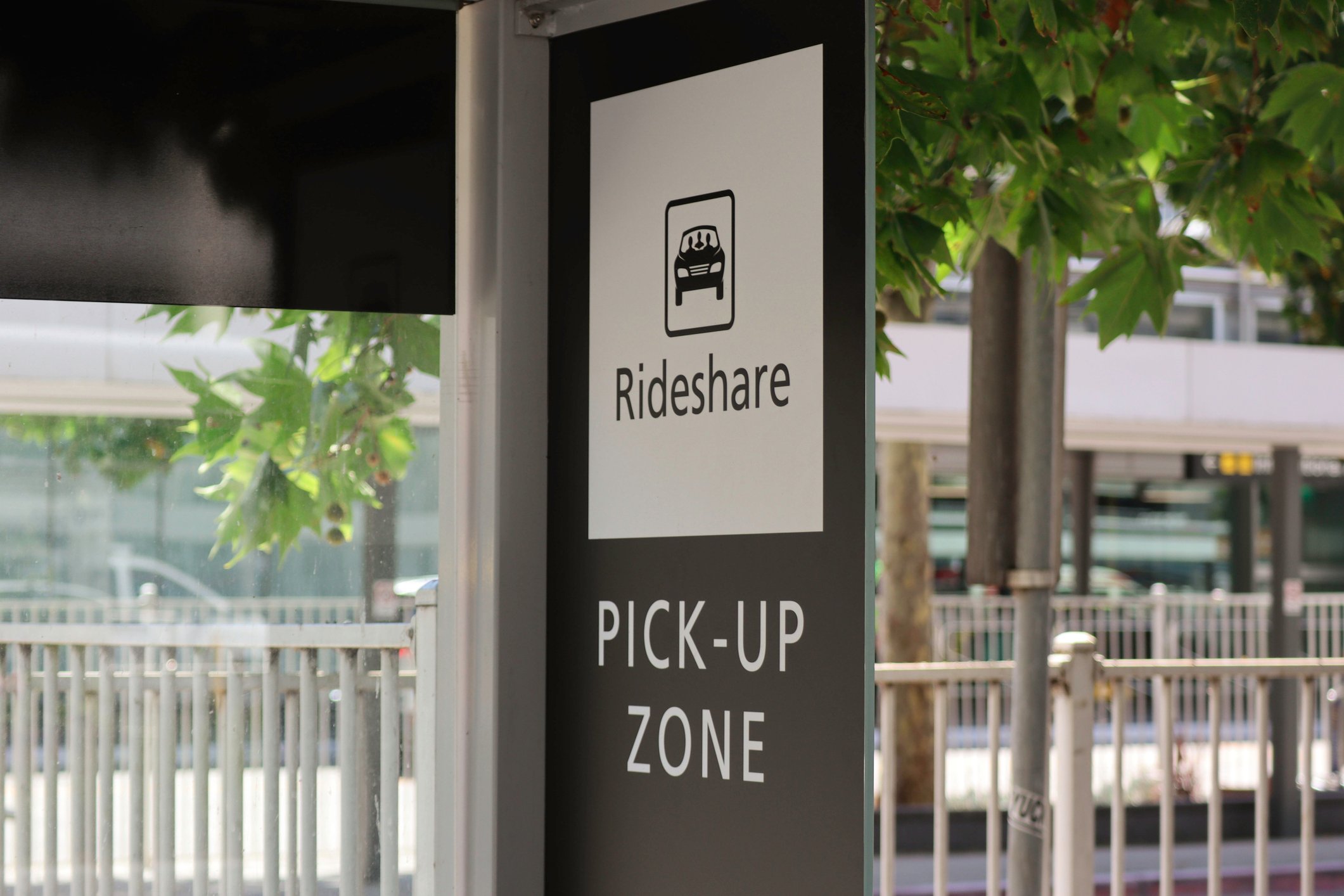 Sign showing the rideshare pick-up zone at a public transit stop.