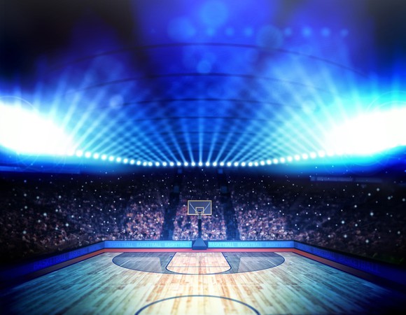A basketball arena all lit up.