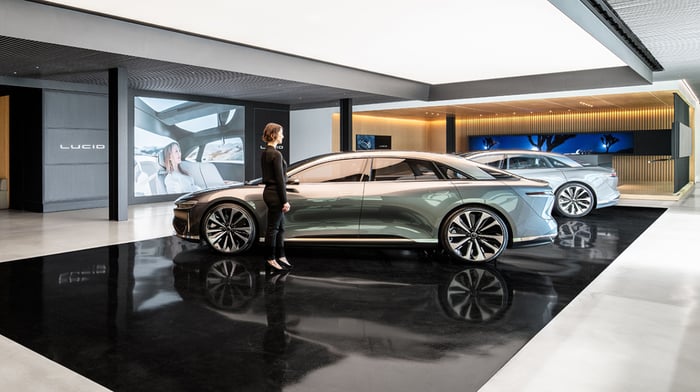 A woman stands in a Lucid showroom.