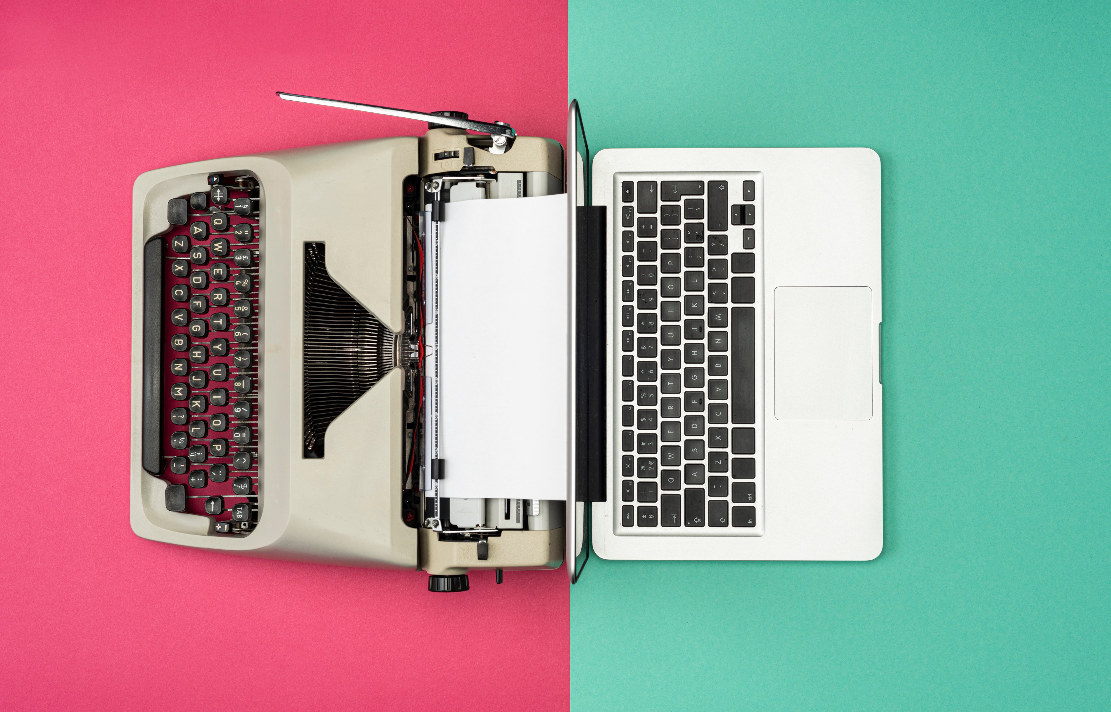 A Typewriter next to a laptop to signify the shift to the digital era. 