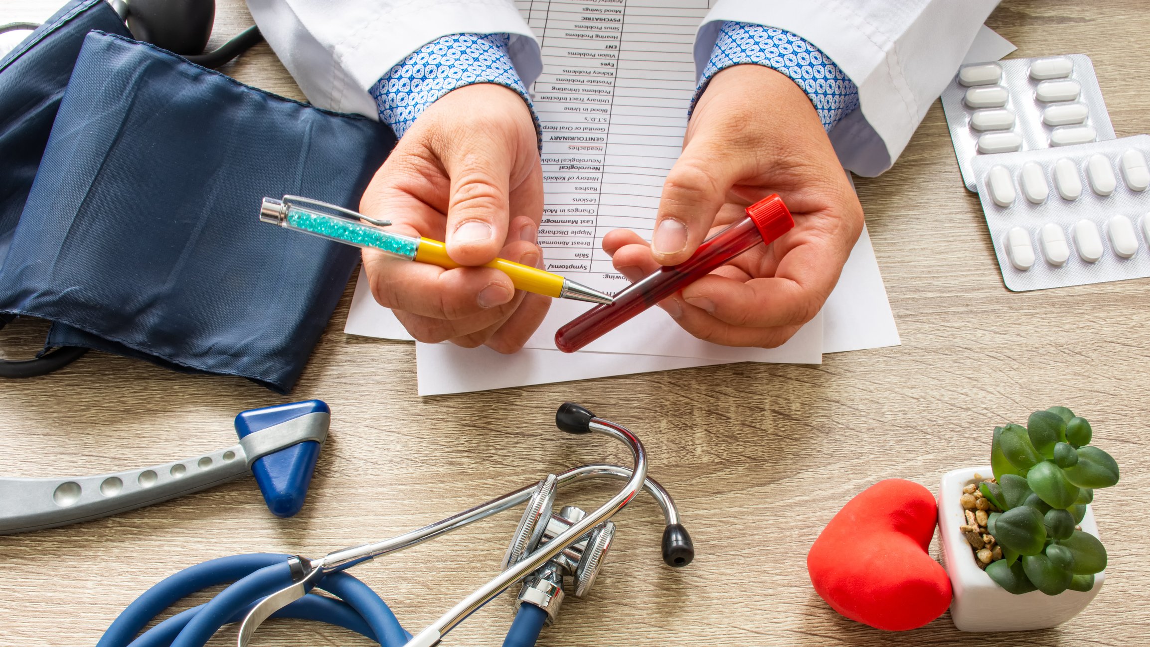 Doctor pointing to a blood vial with a pen