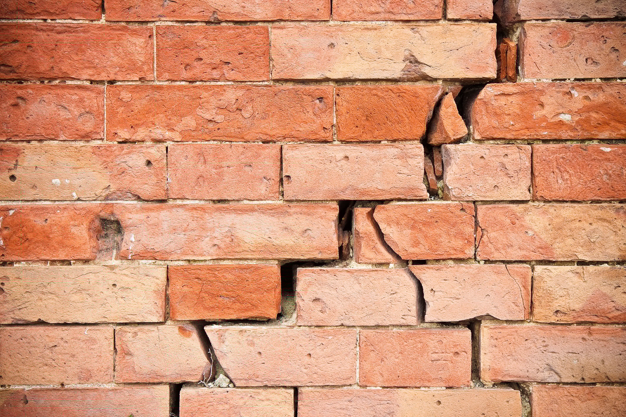Brick wall with severe cracks.