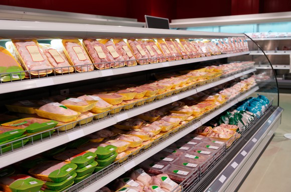 Chicken packages on grocery store shelves