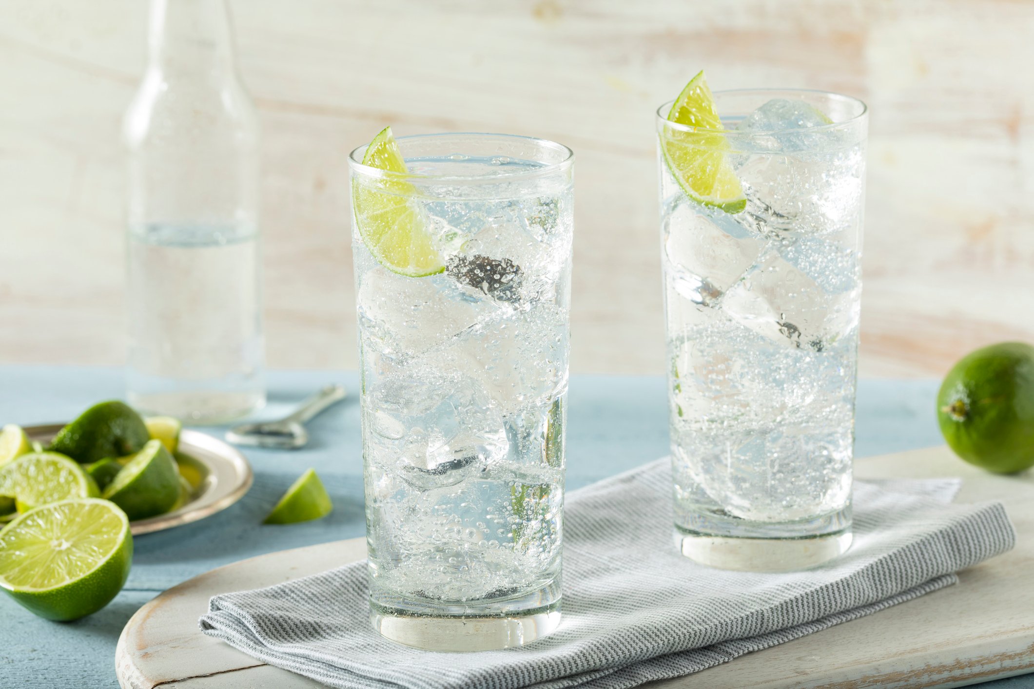Two glasses of hard seltzer with limes.