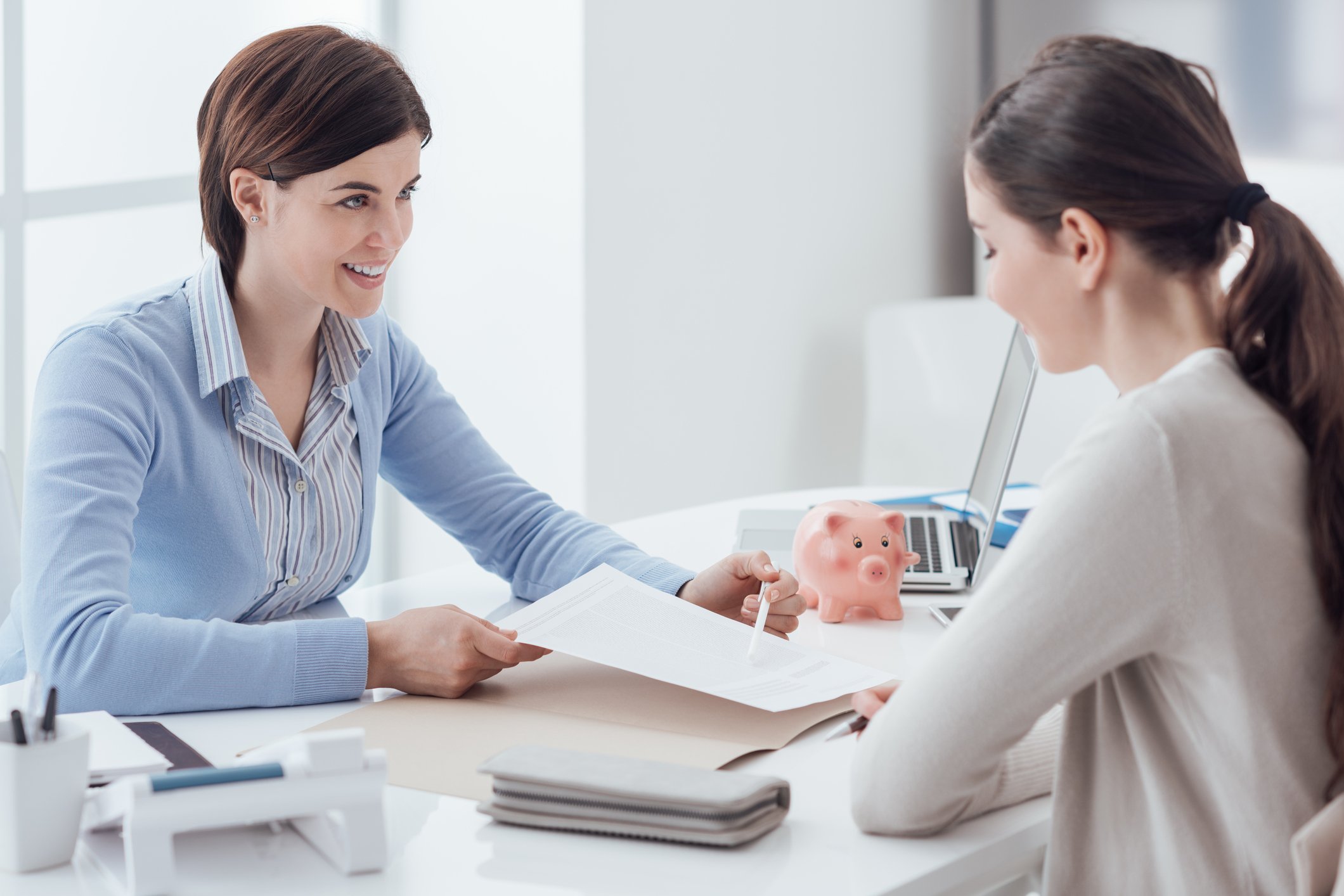 Financial adviser working on a plan with a young woman.