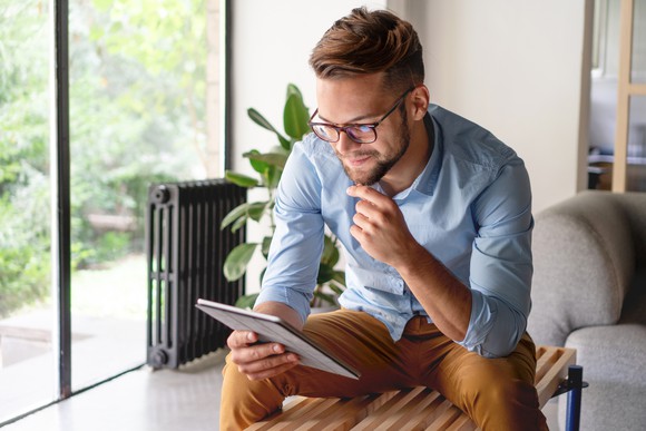 Man staring into tablet computer
