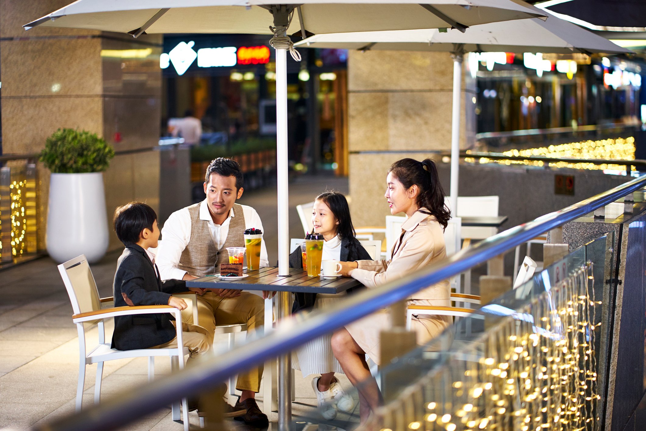 A family sits at a coffee shop.