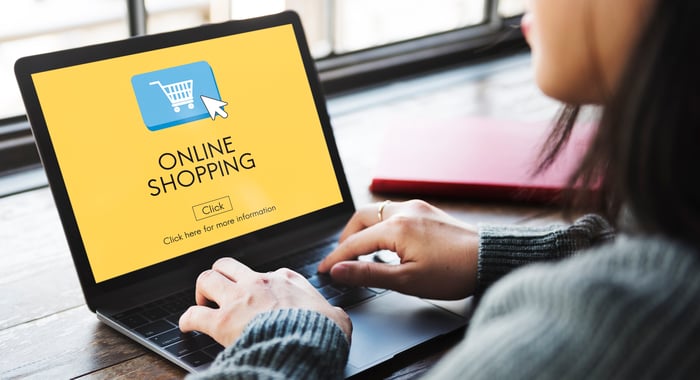 A woman using a laptop to shop online.
