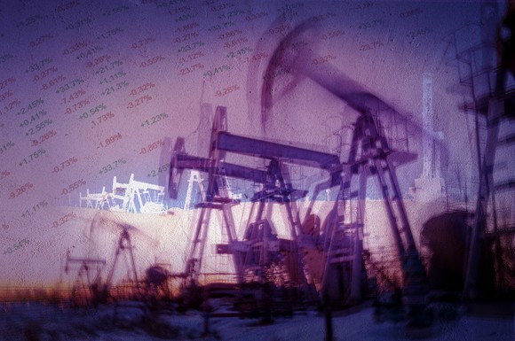 Oil pumps superimposed over a stock index board.