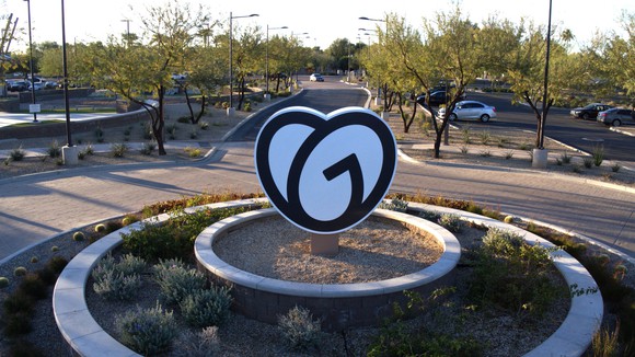 GoDaddy logo sign in the middle of a cul de sac front of Tempe office