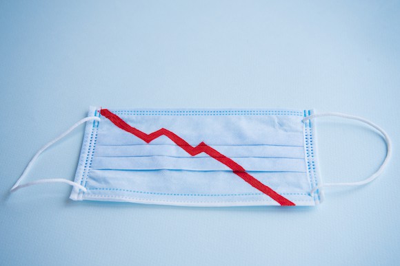 Blue medical mask with falling stock market line on it
