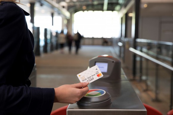 A woman using Mastercard-branded contactless pay credit card.