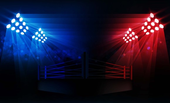 A wrestling ring lit with blue and red lights. 