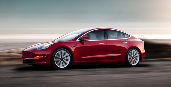 A red Model Y on a road