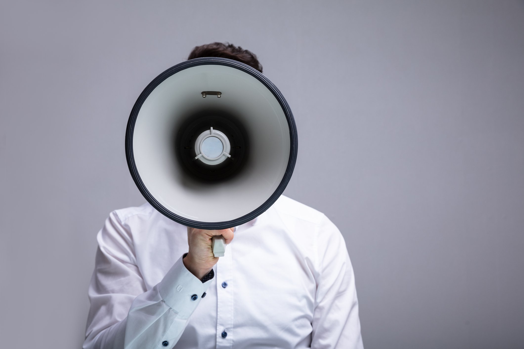 A man speaks through a megaphone.