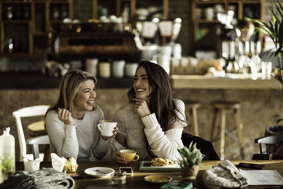 Two ladies having drinks at a cafe. 
