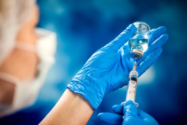 Holding syringe and vaccine bottle