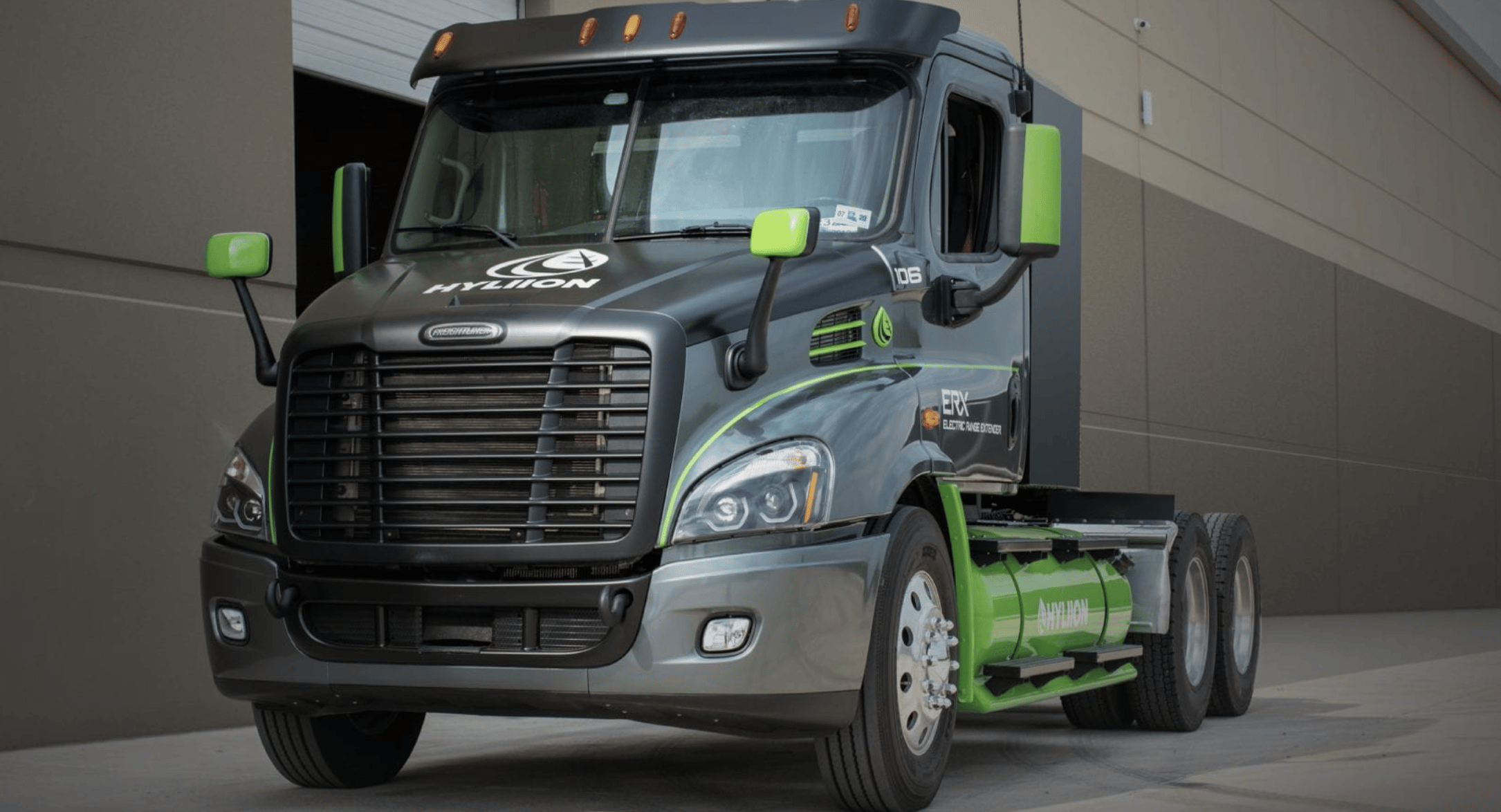 A green and black semi tractor-trailer truck.
