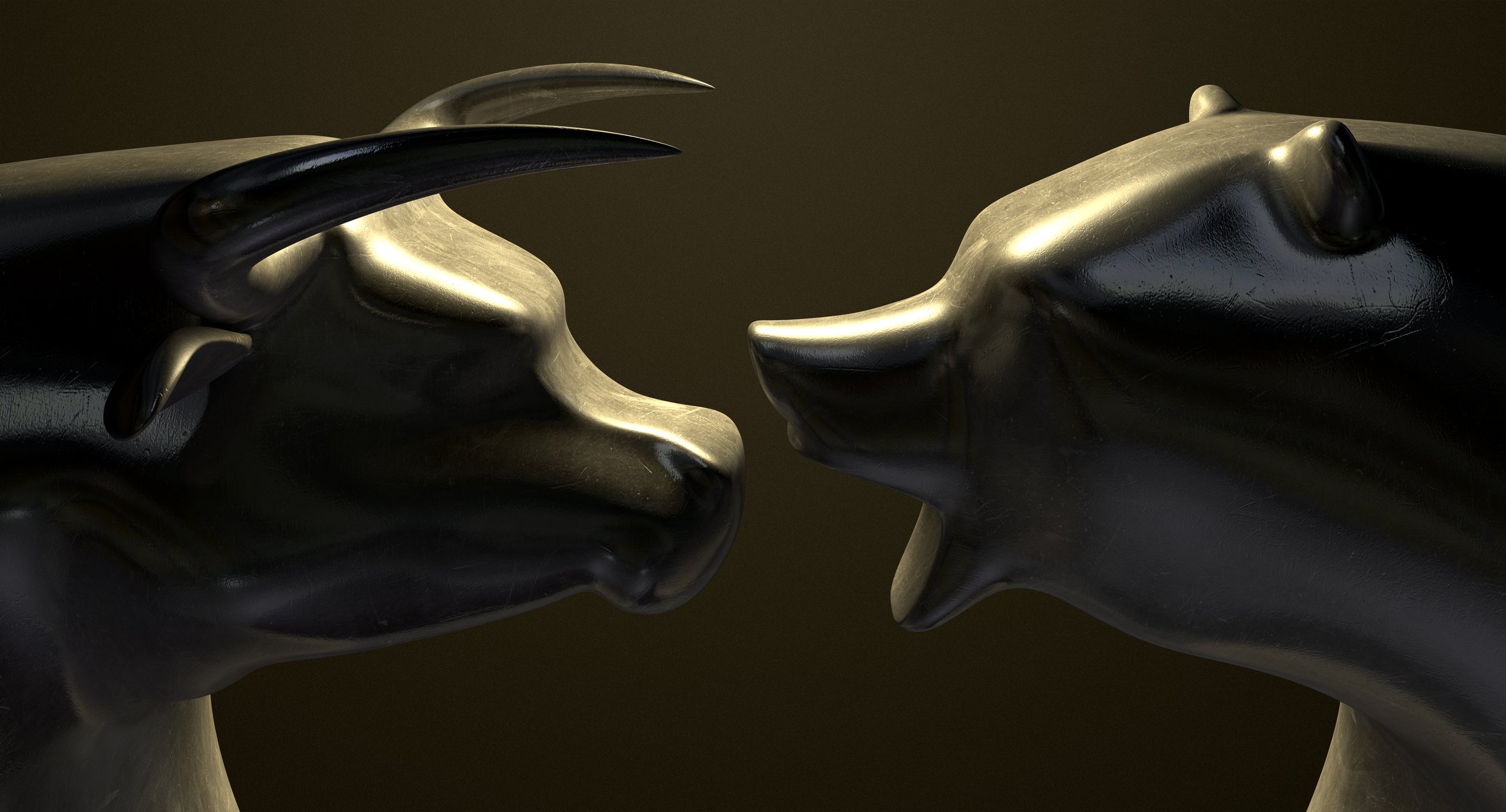 A sculpture of a bull facing a sculpture of a bear.