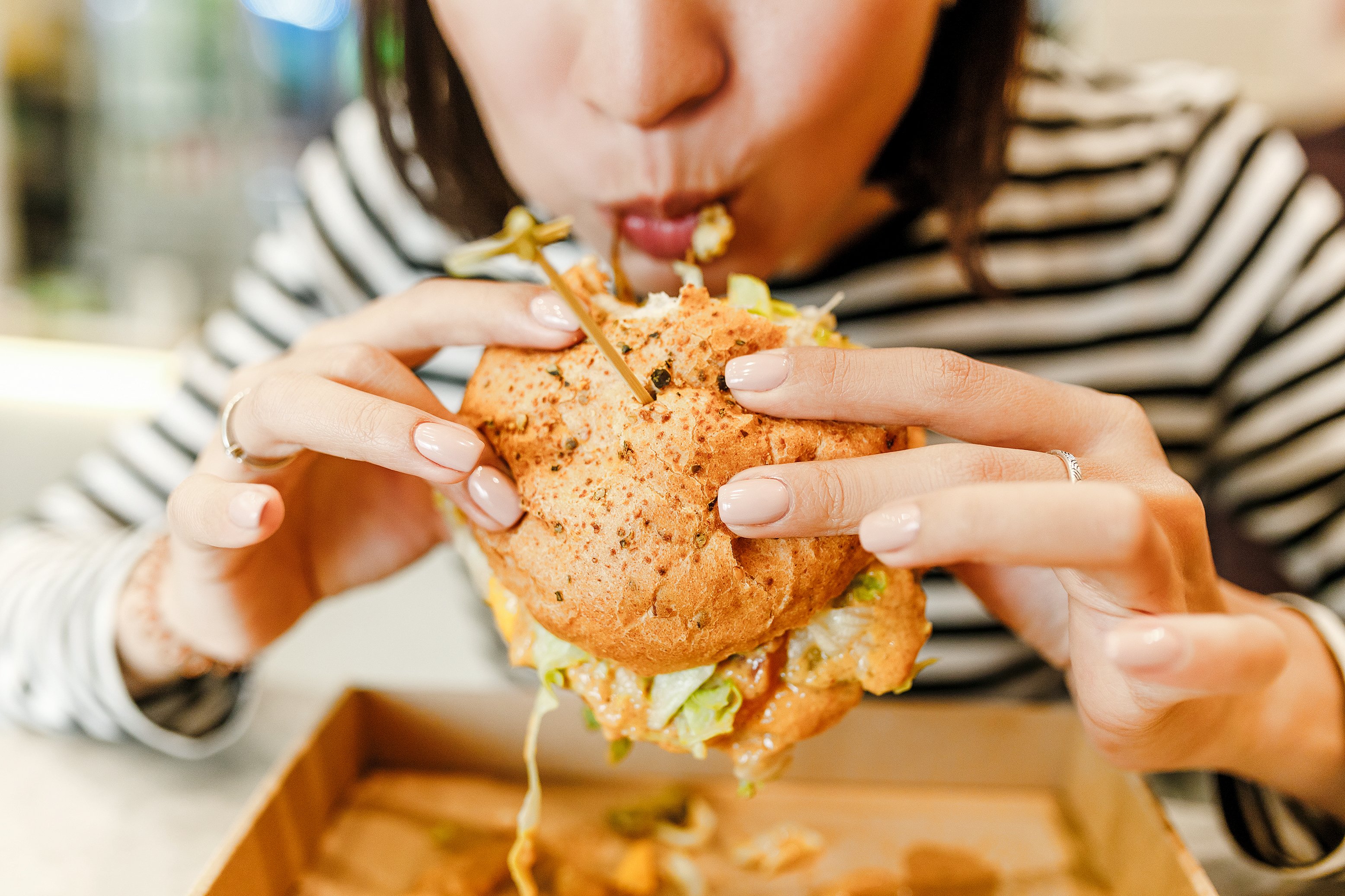 Woman eating a burger.