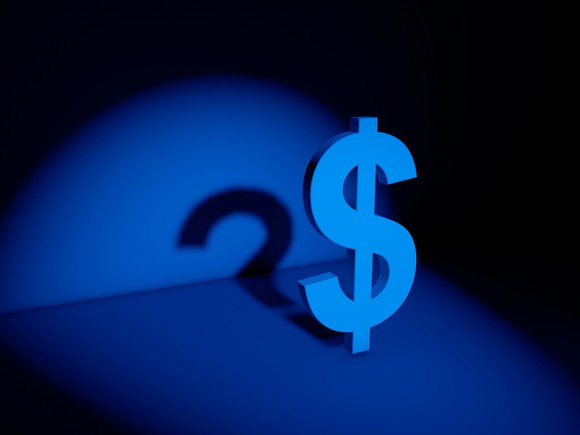 Dollar sign casting a shadow shaped liked a question mark