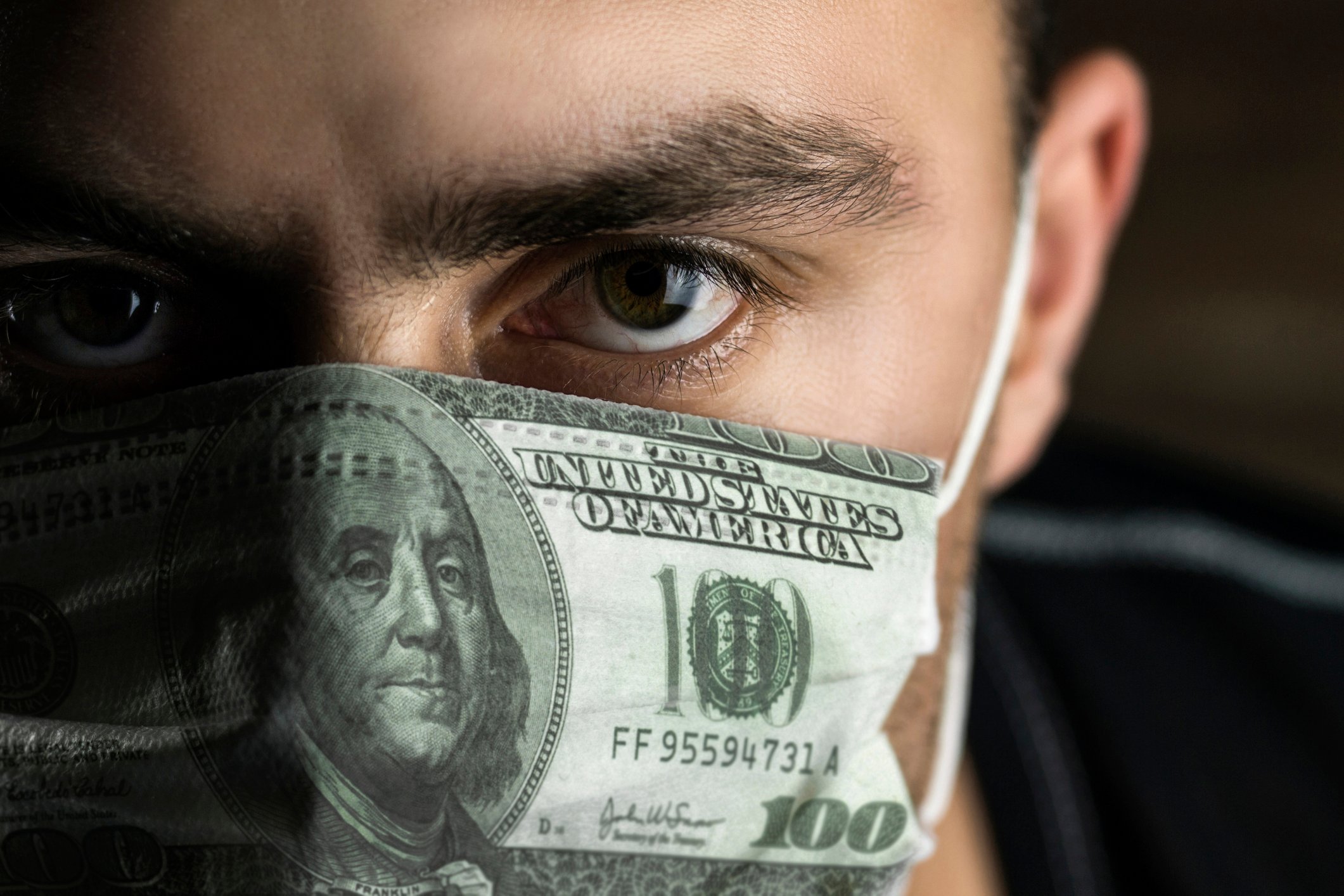 Man with mask that looks like a $100 bill