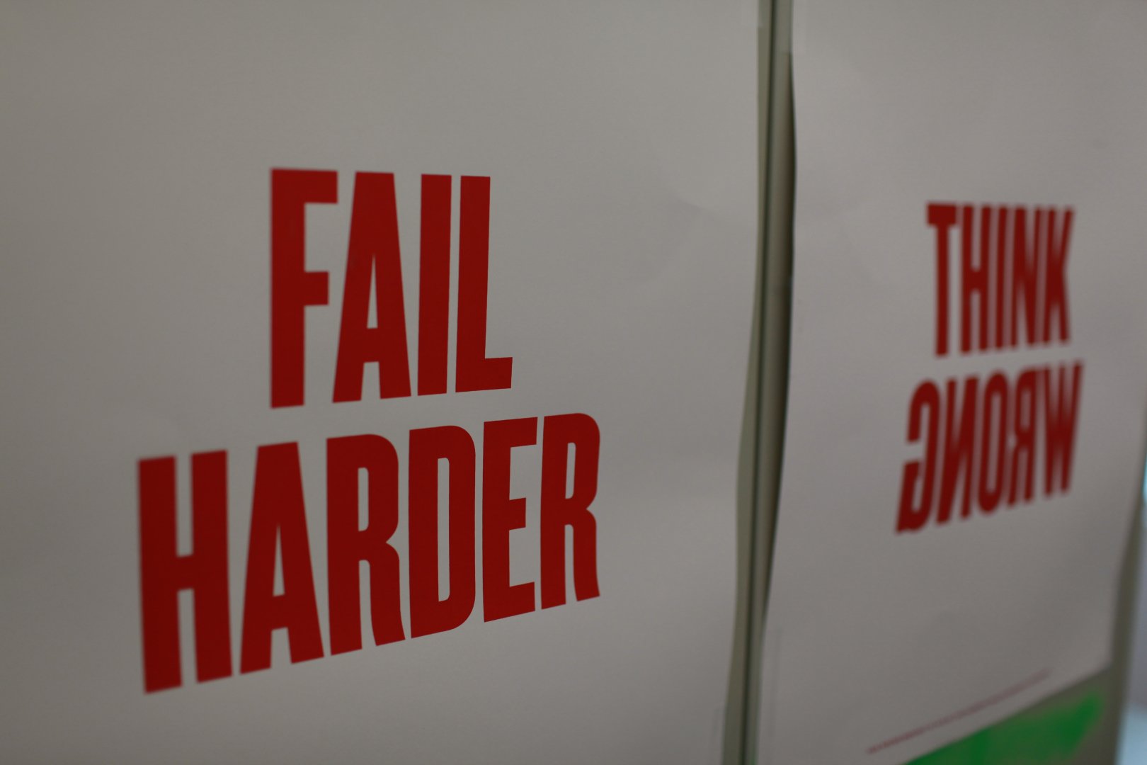 Campus poster that says "Fail Harder" and "Think Wrong"