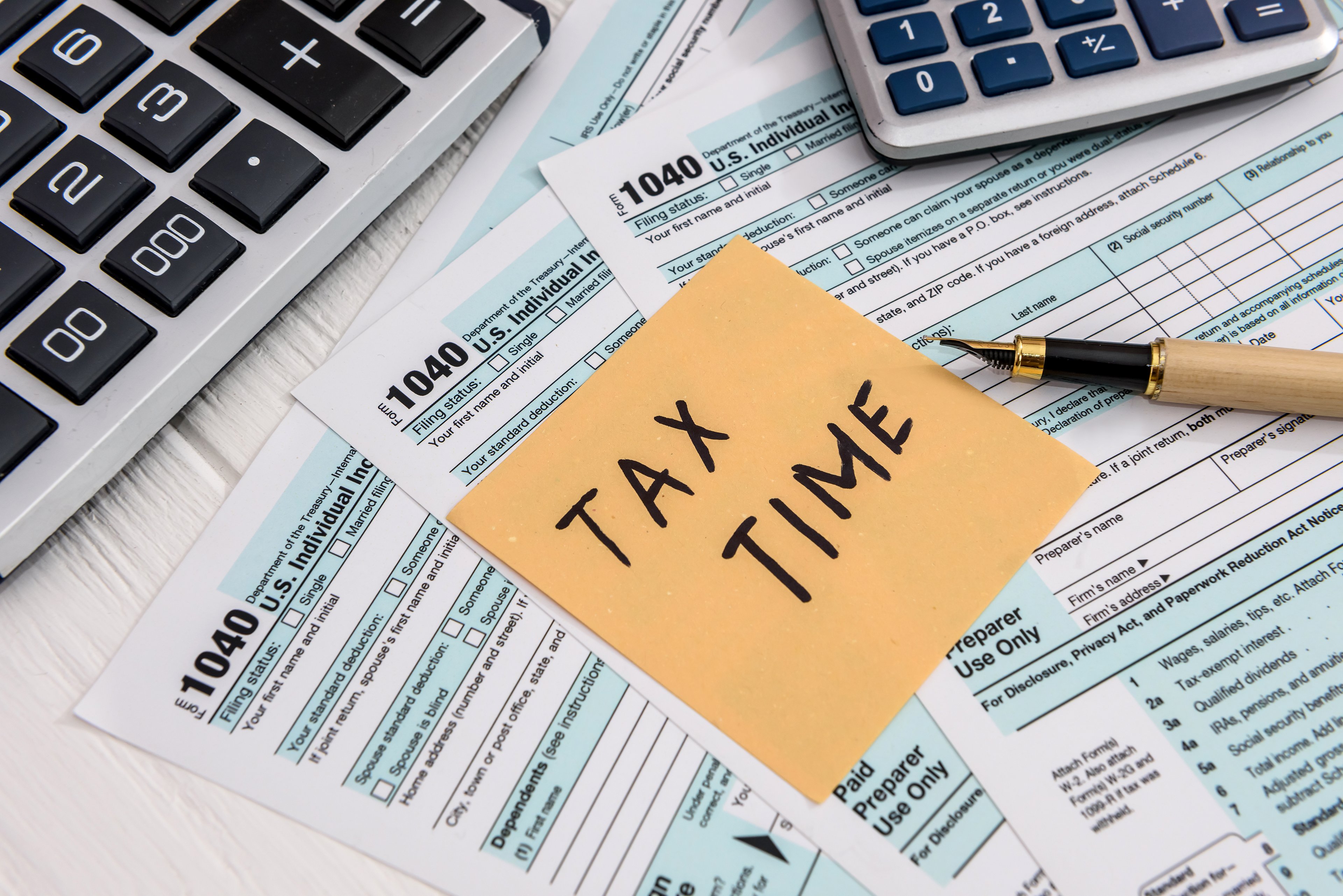 Tax forms and calculators with note that says Tax Time