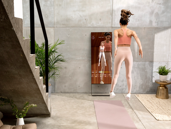 Woman exercising in front of a Mirror mirror