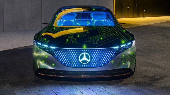 A Mercedes-Benz car covered with bright green computer circuit lines.