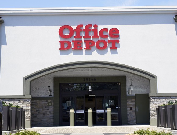 Outside entrance to Office Depot, with logo above the archway