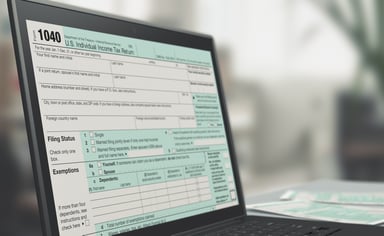 Form 1040 on laptop screen_GettyImages-924341682