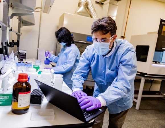 Workers in an Amazon testing lab