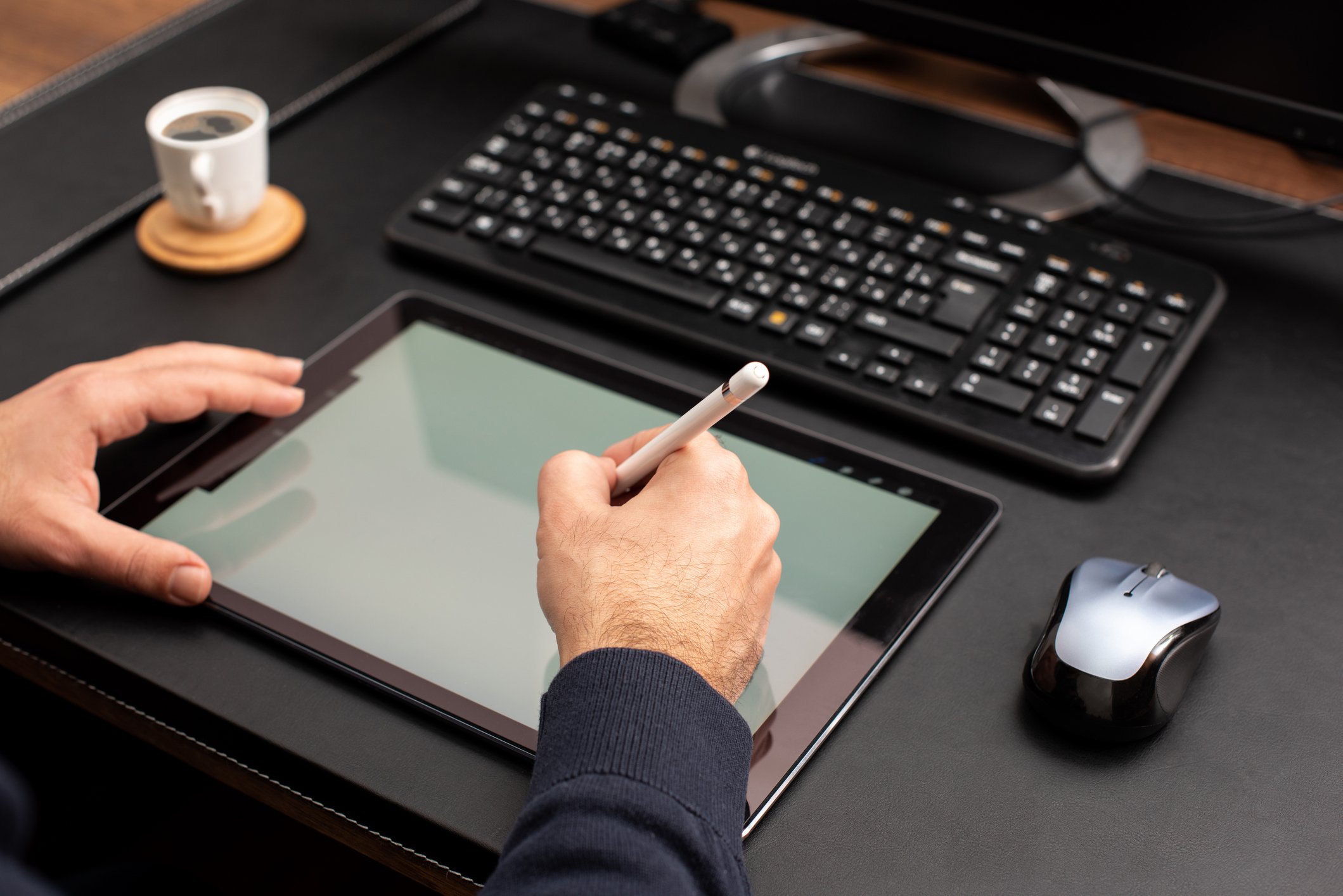 Person writing on tablet with stylus