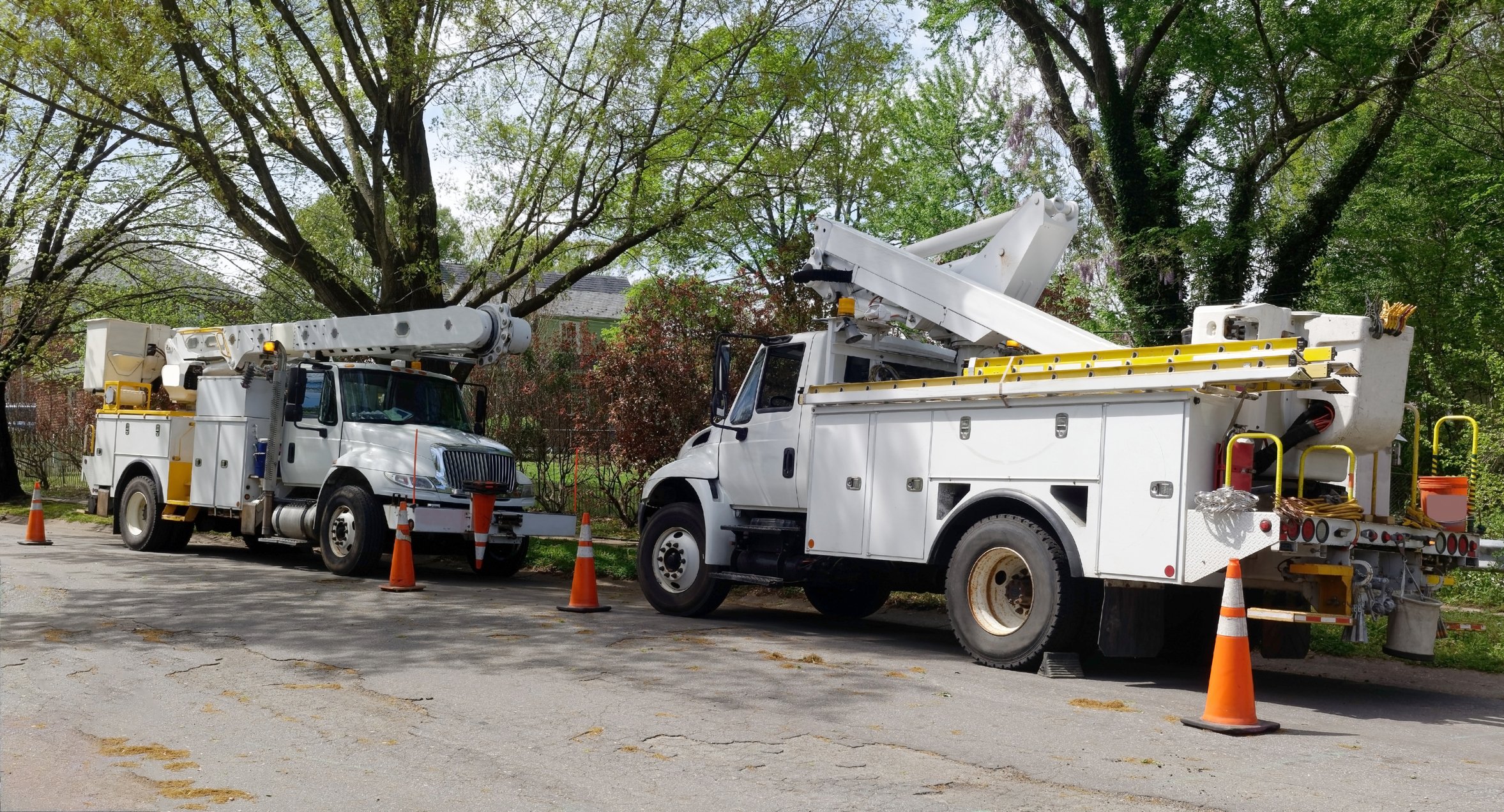 Utility vehicles on a residential street.