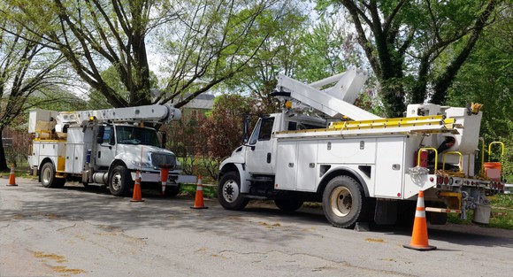 Utility vehicles on a residential street.