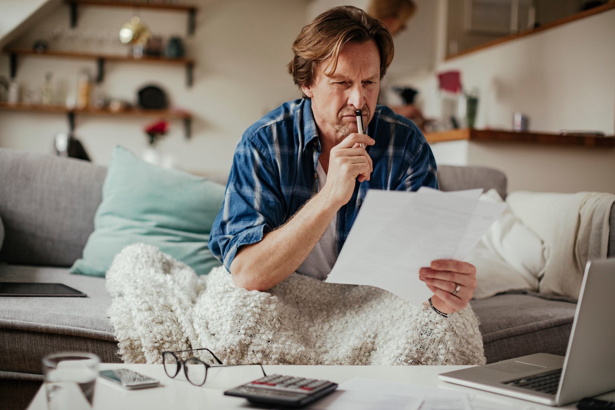 Man with serious expression holding document