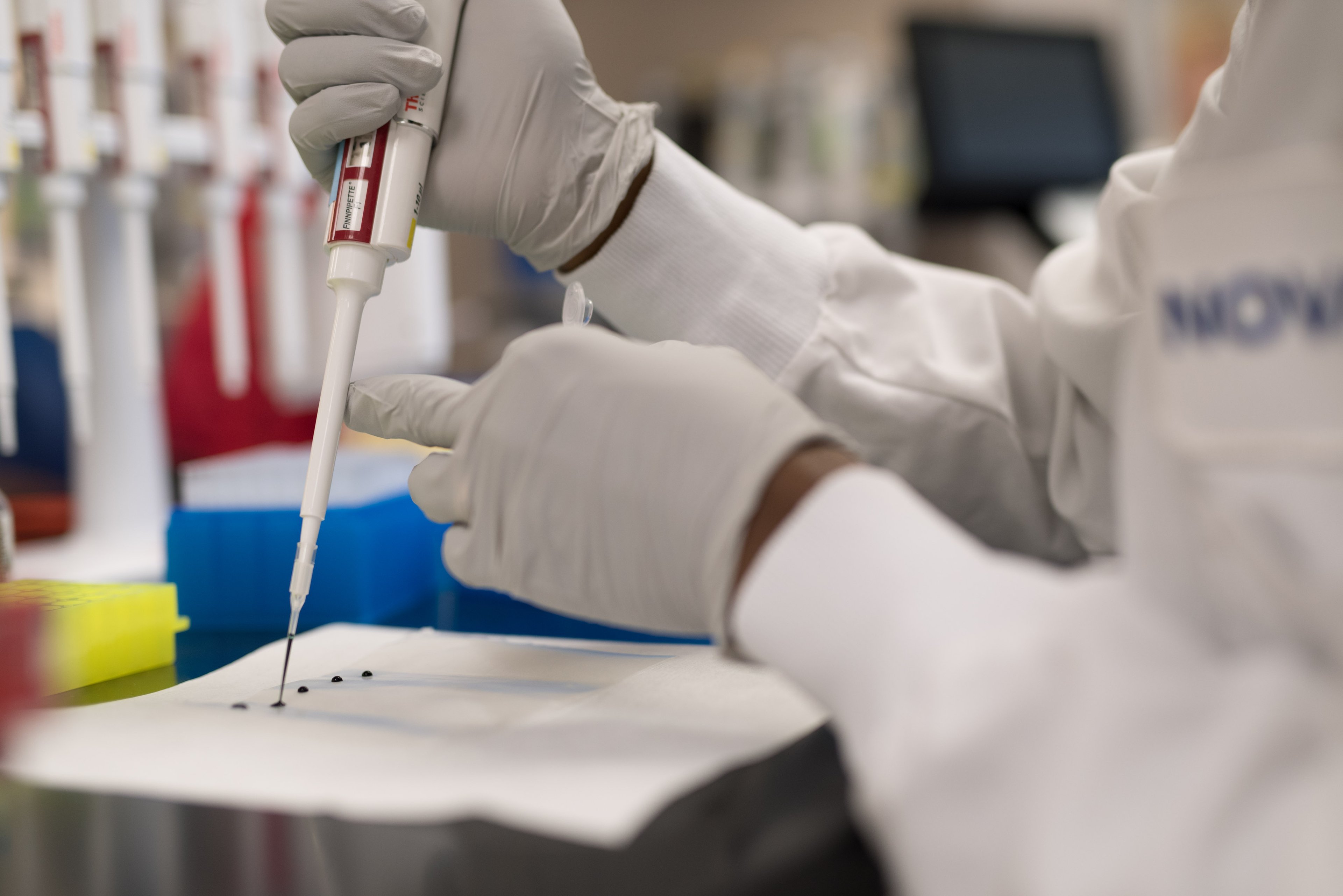 Novavax scientist holding instrument