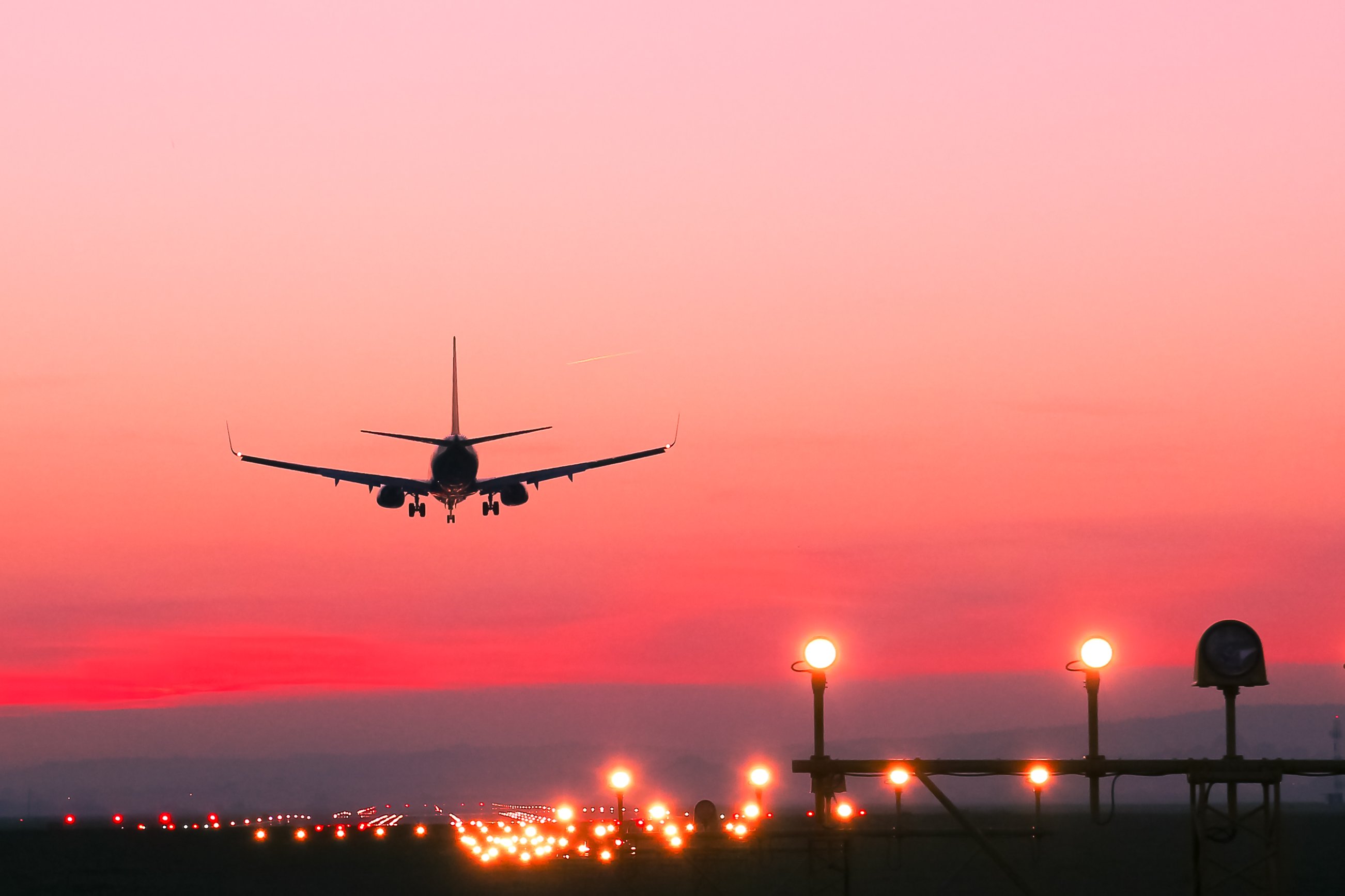 Airplane taking off at sunset