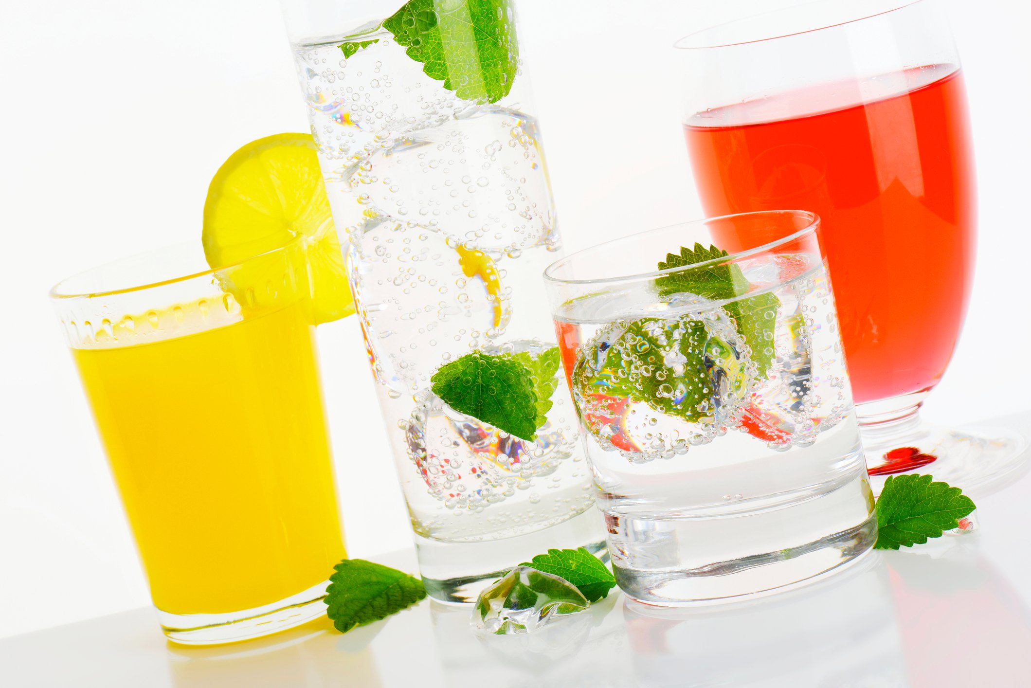 Glasses of hard seltzer with mint and juices
