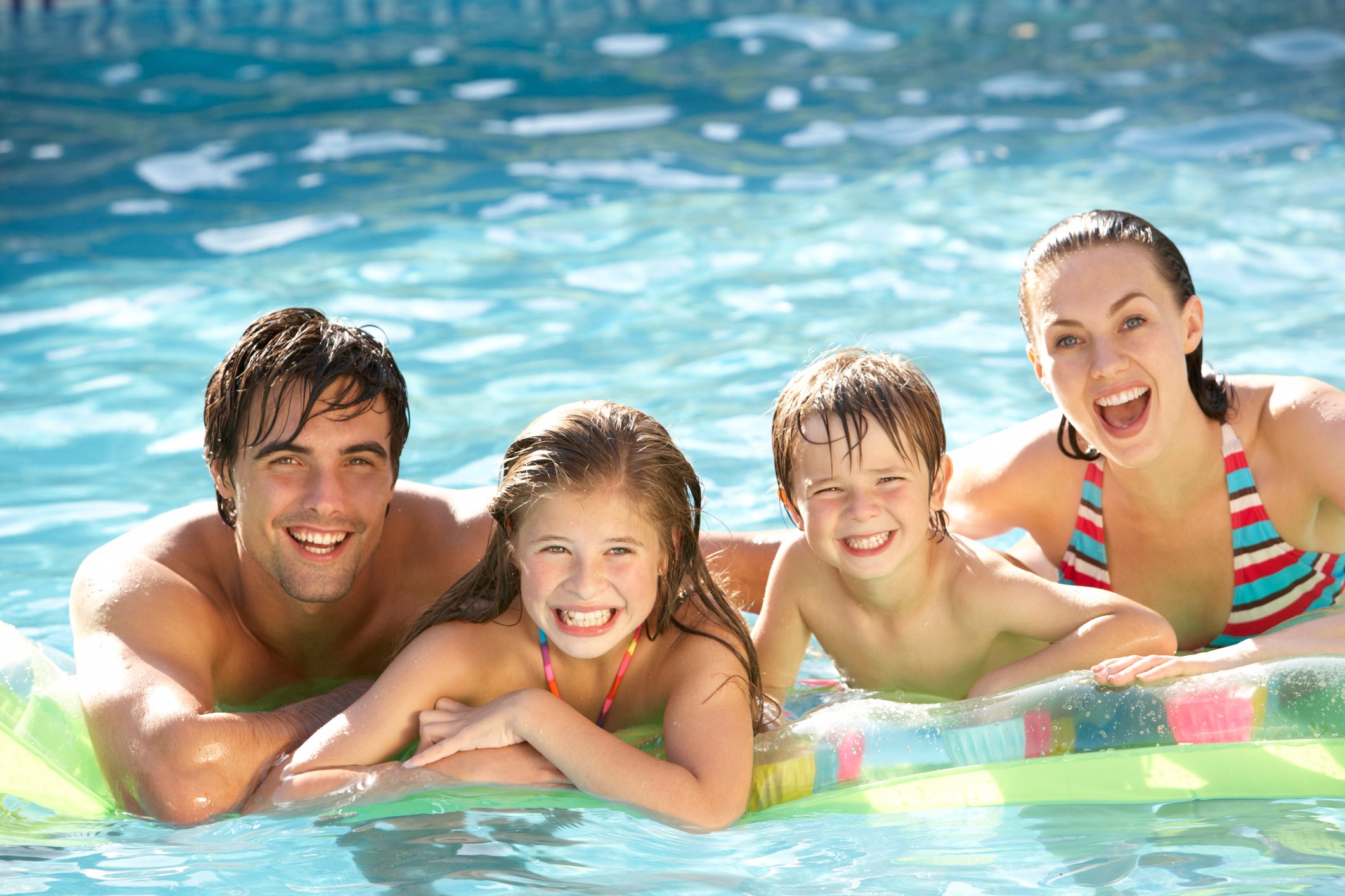 A family  in a swimming pool.