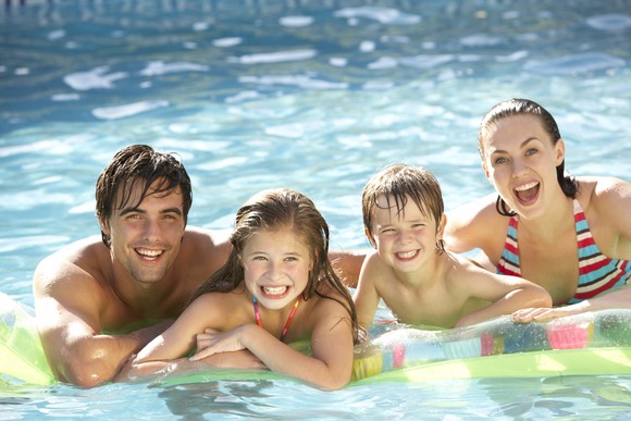 A family  in a swimming pool.