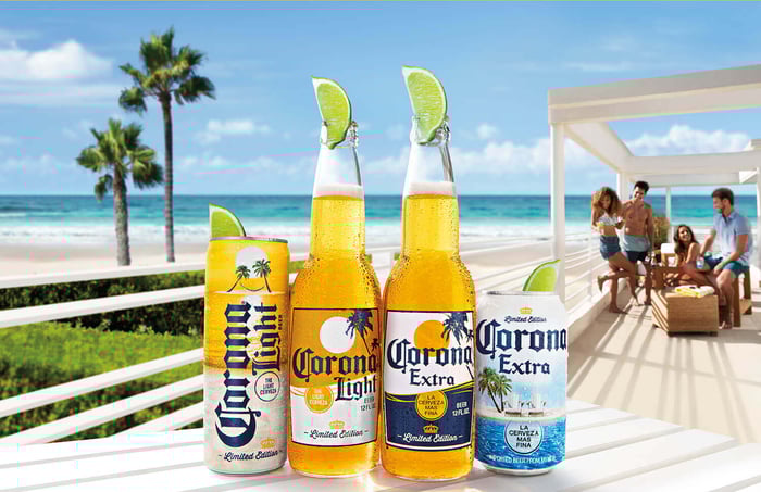 Bottles and cans of Corona beer on table at beach
