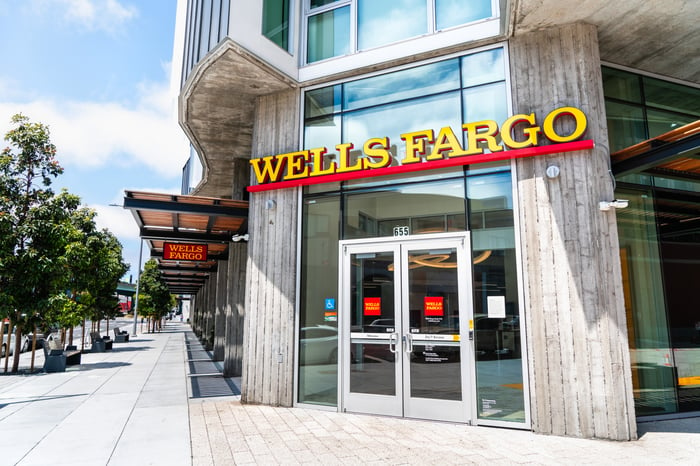 The front doors of a Wells Fargo branch in a city.