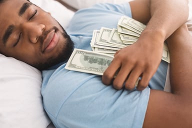 Sleeping man holding cash