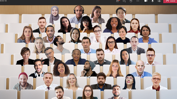 Images of a large number of people superimposed over an auditorium seating view in Team.