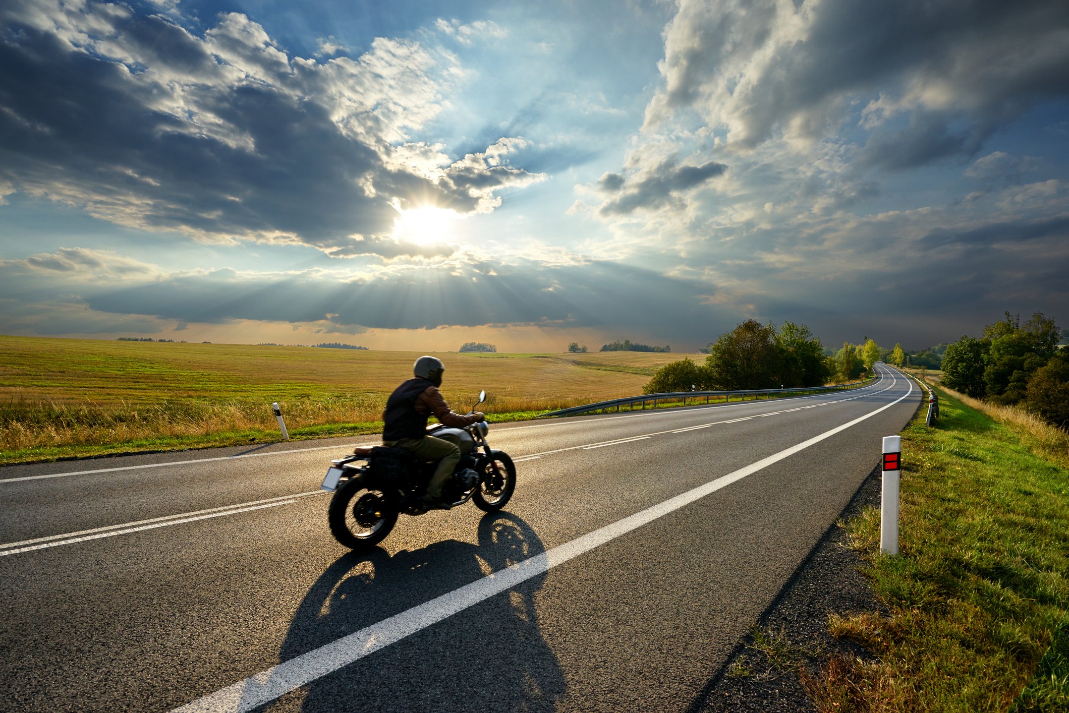 Person riding motorcycle on an open highway 