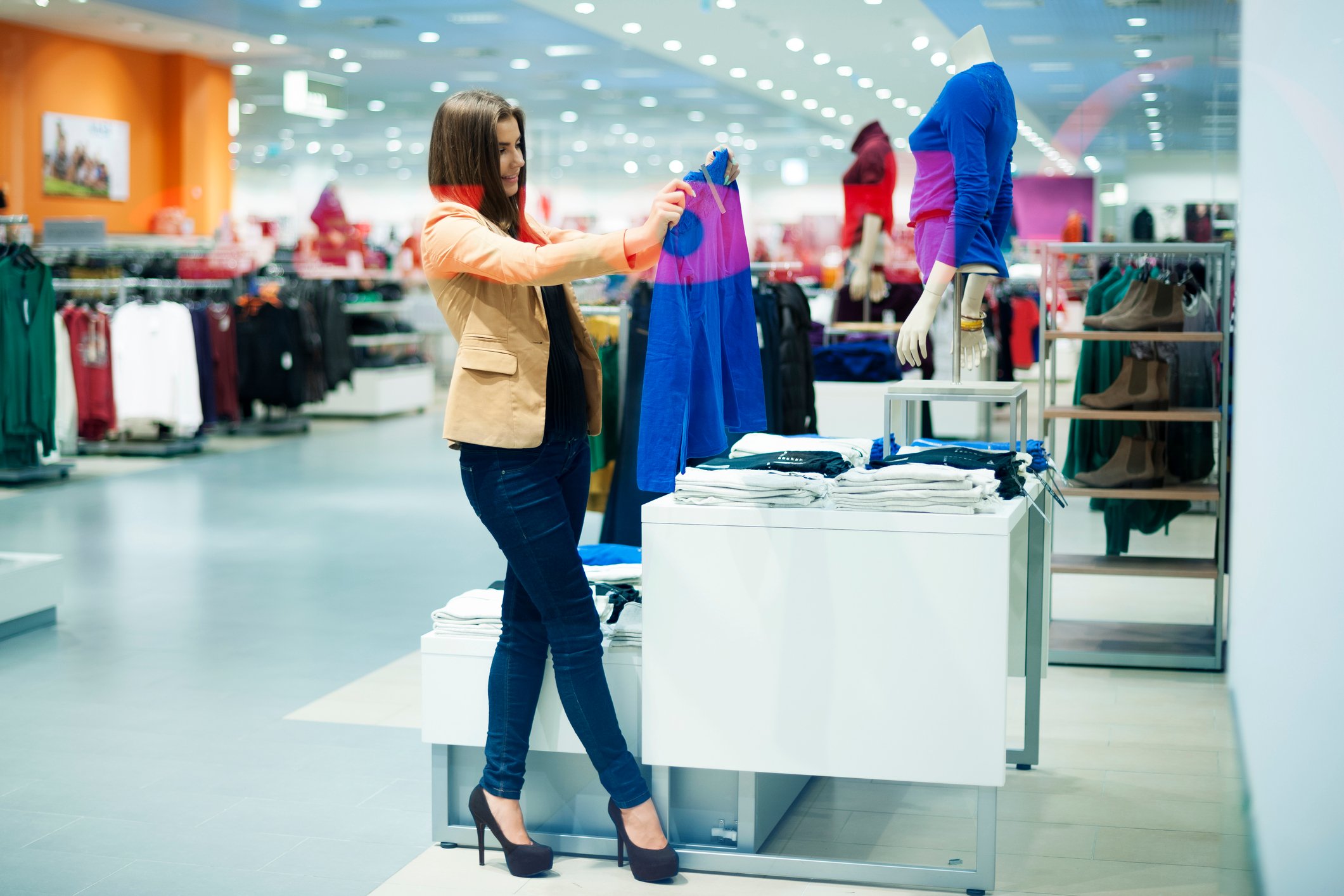 A woman shopping for a jacket.
